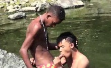 Teen gay swimmer playfully going down in the river