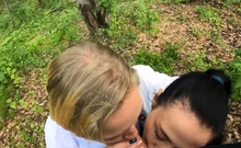 Two Girlfriends Suck Cock in the Wood