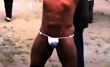 Asian bodybuilder barely covered at the beach